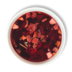 Vernal Muse fruit tea by Holy Tea brewed hot, showcasing deep ruby color with visible berries and fruit pieces