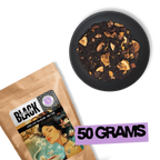 Caravan of Palmyra loose leaf black tea 50g pouch with dried fruit and almond blend displayed on black background.