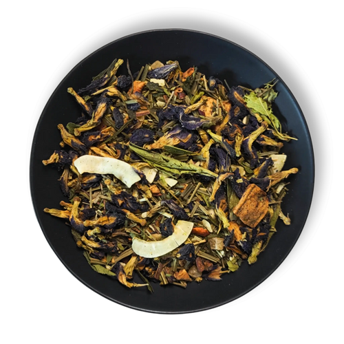 Azure Alchemy golden blue loose leaf herbal tea blend with butterfly pea flowers, lemongrass and coconut flakes in black bowl