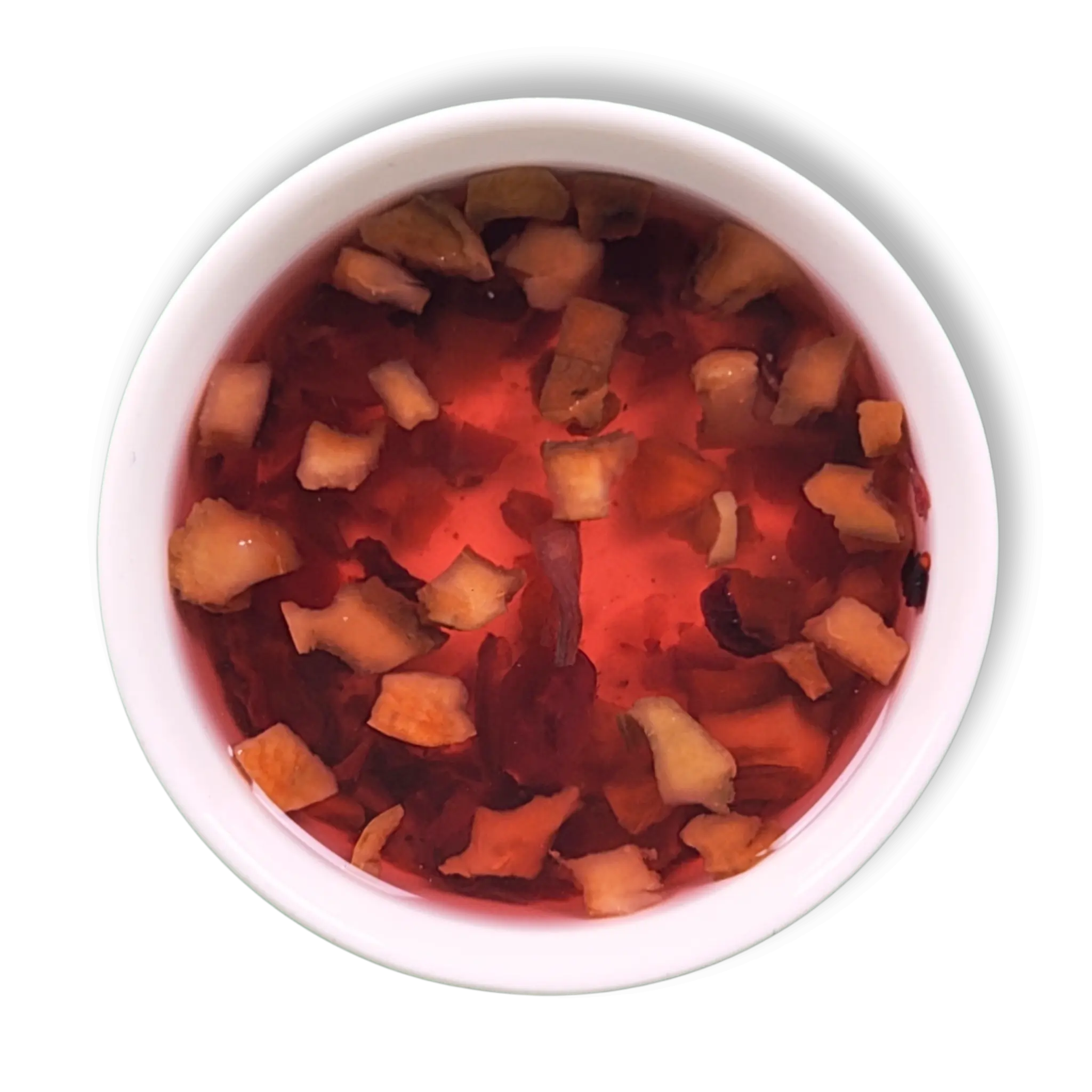 Crimson Orchard berry fruit tea infusion in a white cup showing bright red hibiscus and cranberry brew with apple pieces