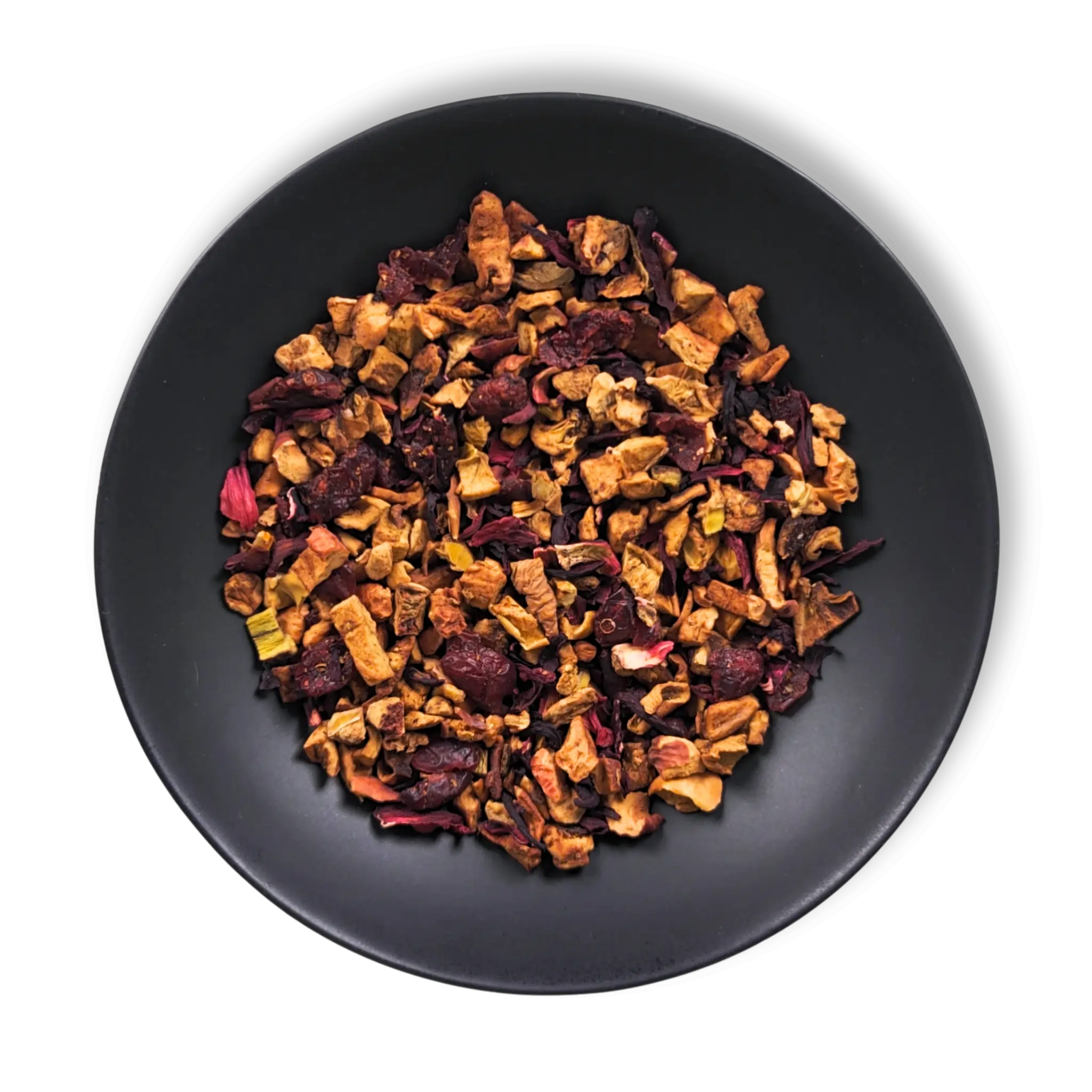 Crimson Orchard loose-leaf fruit tea blend with apple, hibiscus and cranberry displayed on a black plate