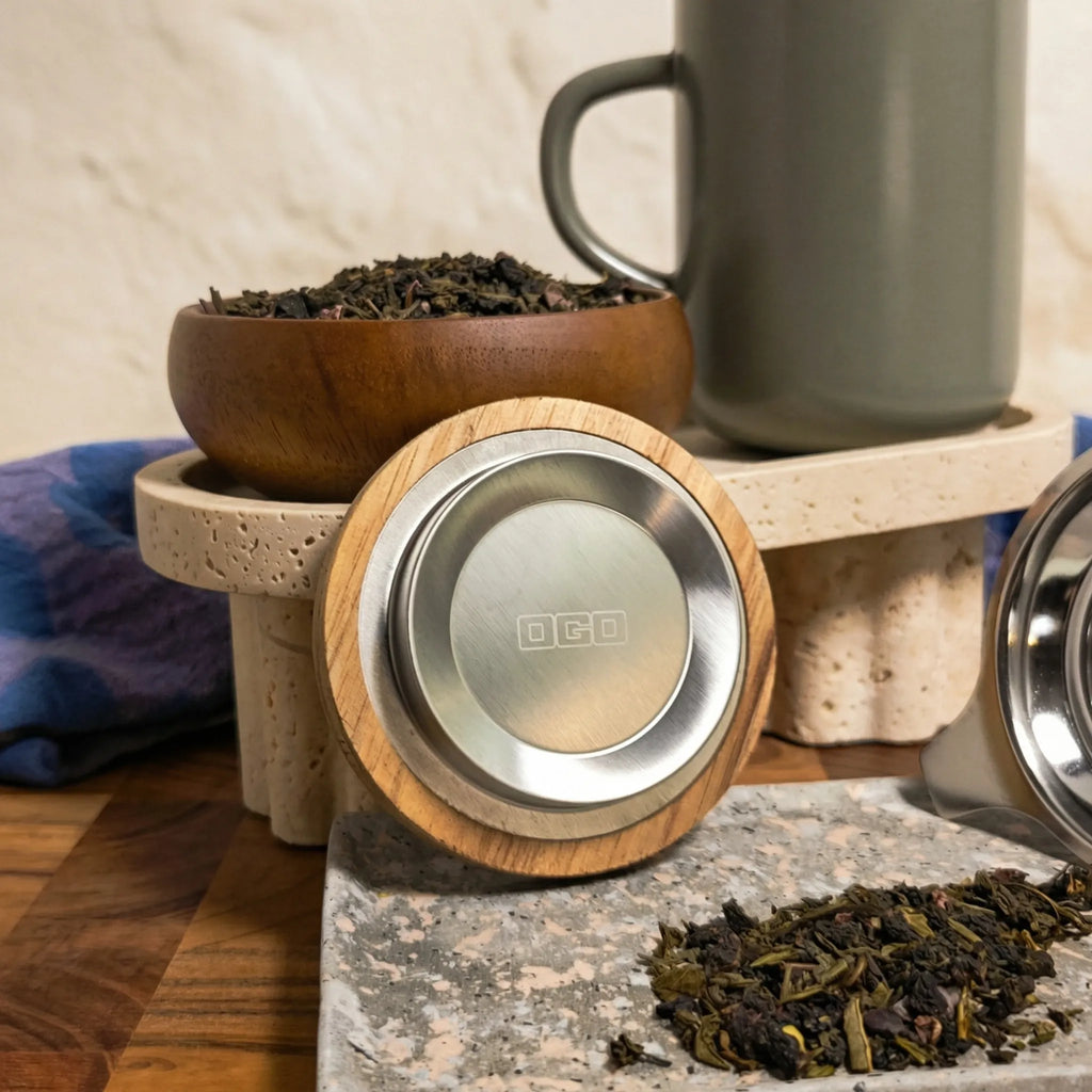 Close-up of acacia wood lid with stainless steel insert and Almond stoneware tea mug.