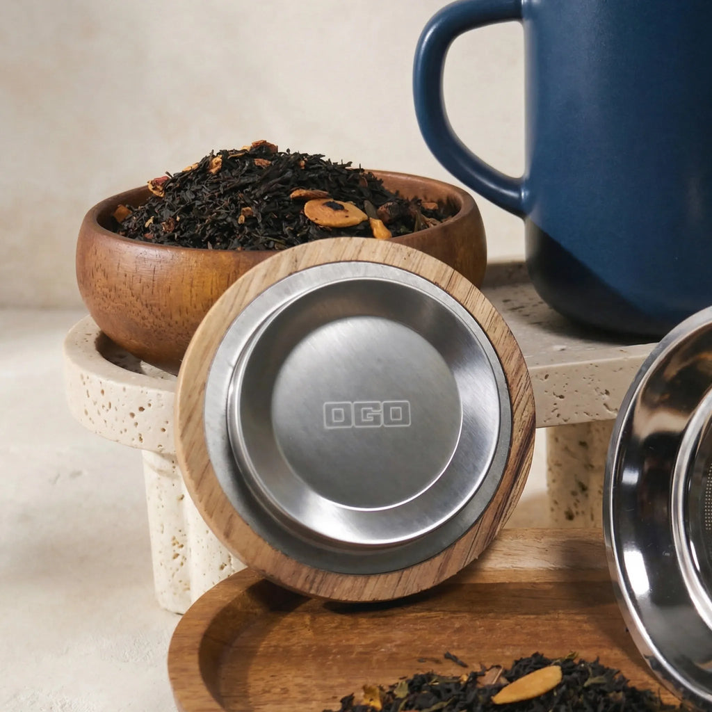 Close-up of acacia wood lid with stainless steel insert and Blue stoneware tea mug.