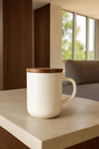 Juliet White 475 ml tea mug with acacia lid on a table with loose-leaf tea